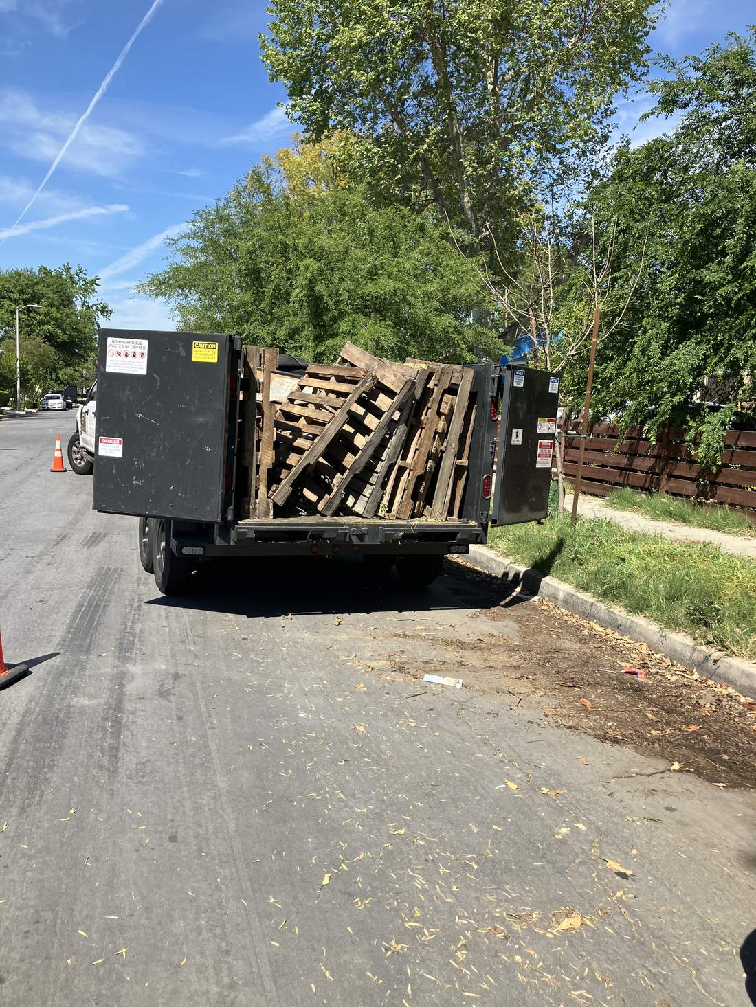 818 Junk trailer loaded with wood pallets on a job